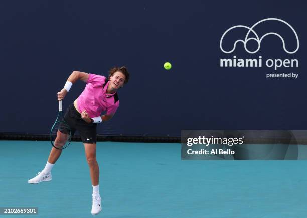 Sebastian Korda serves with Andy Murray of Great Britain against Julian Cash of Great Britain and Tallon Griekspoor of the Netherlands during their...