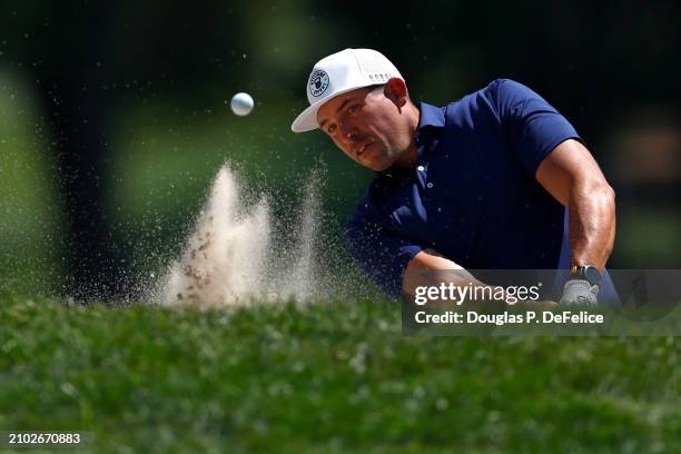 Scott Stallings of the United States plays a shot from a bunker on the 18th hole during the first round of the Valspar Championship at Copperhead...