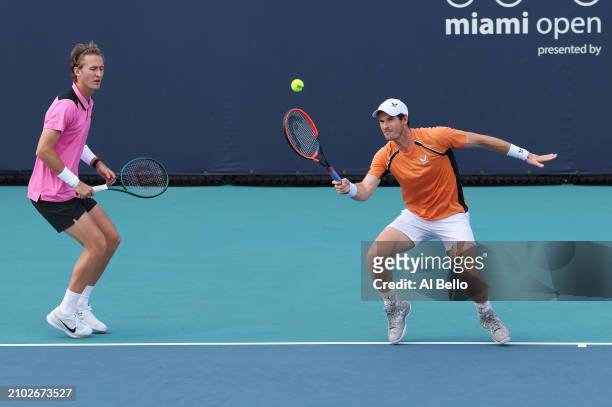 Andy Murray of Great Britain returns a shot with Sebastian Korda against Julian Cash of Great Britain and Tallon Griekspoor of the Netherlands during...