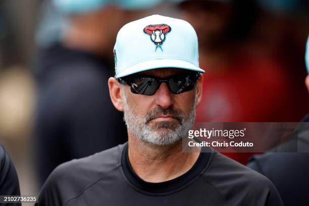 Manager Torey Lovullo of the Arizona Diamondbacks walks in the dugout before a spring training game against the Oakland Athletics at Salt River...
