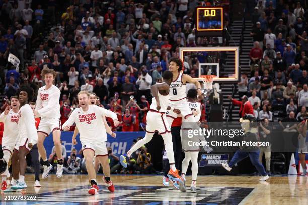 Javon Bennett and Kobe Elvis of the Dayton Flyers celebrate defeating the Nevada Wolf Pack 63-60 in the first round of the NCAA Men's Basketball...