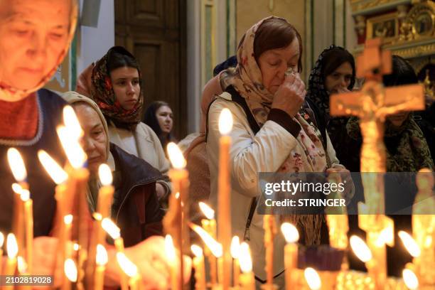 People attend a memorial service at the Alexander Nevsky Cathedral in Simferopol, Crimea, on March 24 as Russia observes a national day of mourning...