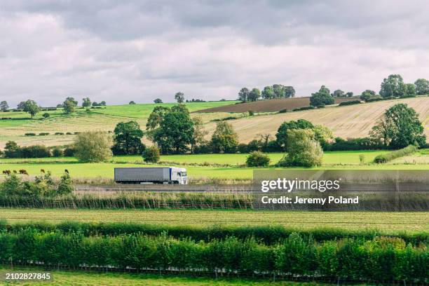 articulated lorry driving south in rural united kingdom north of london - truck stock pictures, royalty-free photos & images