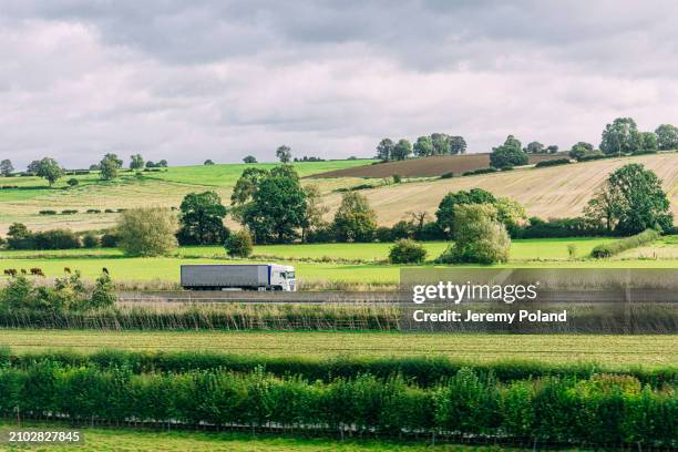 articulated lorry driving south in rural united kingdom north of london - we're on the move stock pictures, royalty-free photos & images