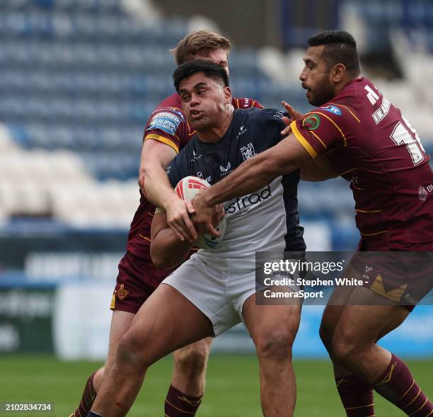 Hull FC's Herman Ese'ese is tackled by Huddersfield Giants' Sebastine Ikahihifo and Jack Murchie during the Betfred Challenge Cup Round 6 match...