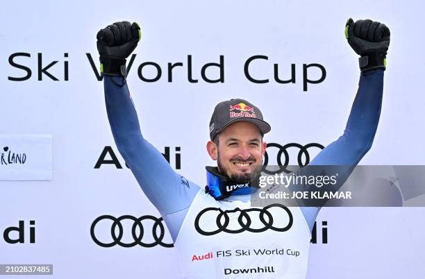 The third placed in the overall Men's Downhill competition of the FIS Alpine Skiing World Cup Italy's Dominik Paris celebrates on the podium after...