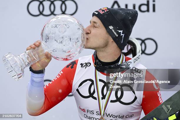 Marco Odermatt of Team Switzerland wins the globe in the overall standings during the Audi FIS Alpine Ski World Cup Finals Men on March 24, 2024 in...