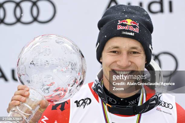 Marco Odermatt of Team Switzerland wins the globe in the overall standings during the Audi FIS Alpine Ski World Cup Finals Men on March 24, 2024 in...