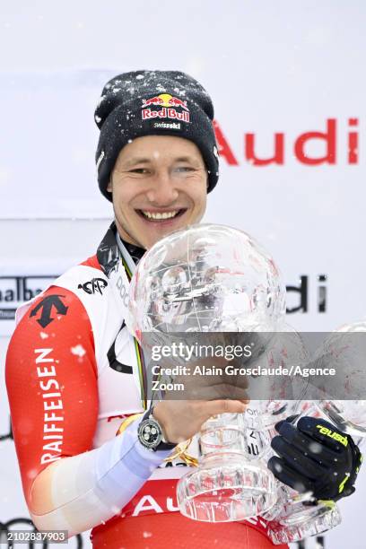 Marco Odermatt of Team Switzerland wins the globe in the overall standings during the Audi FIS Alpine Ski World Cup Finals Men on March 24, 2024 in...