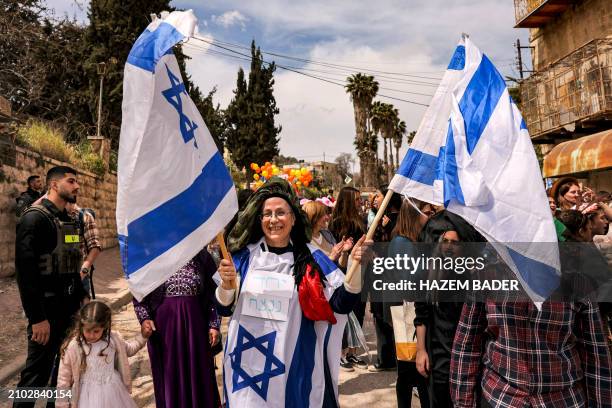Orit Malka Strook , the Israeli Minister of Settlements and National Missions and parliament member, stands holding Israeli flags and draped in one...