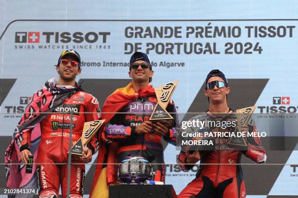 Winner Ducati Spanish rider Jorge Martin , second placed Ducati Italian rider Enea Bastianini and third placed KTM Spanish rider Pedro Acosta hold...