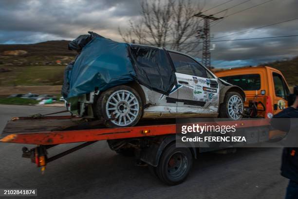 The accidented car is taken away from the road near the crash site where a vehicle taking part in the Esztergom Nyerges Rally veered off from the...