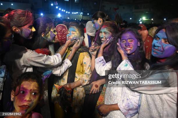 Hindu women celebrate Holi, the spring festival of colours, at the Swami narain Temple in Karachi on March 24, 2024.