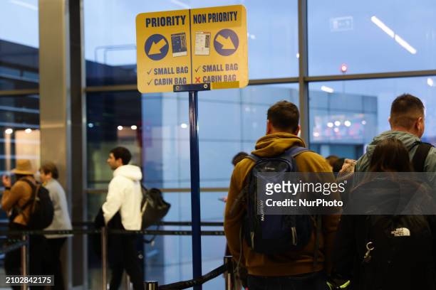 People stay in line before boarding Ryanair plane at the airport in Balice near Krakow, Poland on March 24, 2024.