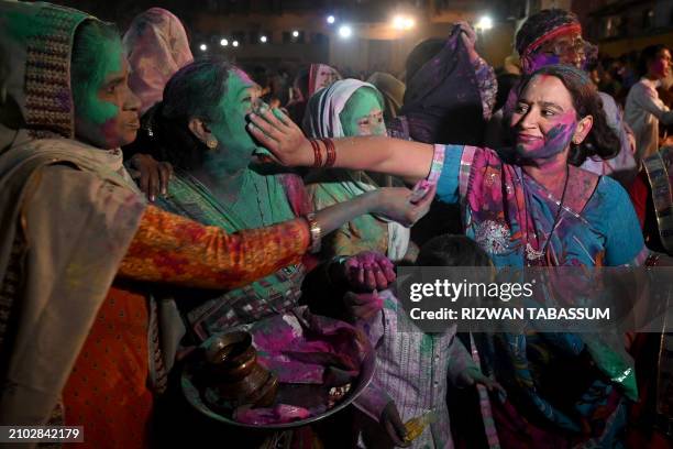 Hindu women celebrate Holi, the spring festival of colours, at the Swami narain Temple in Karachi on March 24, 2024.