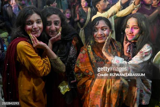 Hindu women celebrate Holi, the spring festival of colours, at the Swami narain Temple in Karachi on March 24, 2024.