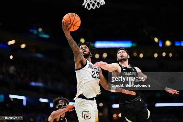 David Joplin of the Marquette Golden Eagles lays up the ball against Luke O'Brien of the Colorado Buffaloes during the second round of the 2024 NCAA...