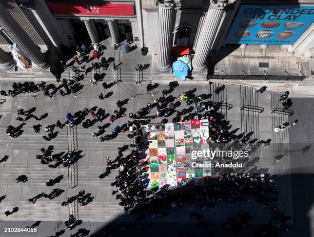 Hundreds of pro-Palestinian supporters, holding banners and flags, gather on the steps of the Metropolitan Museum to hold a pro-Palestinian...