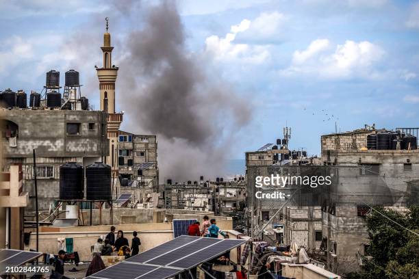 Smoke plume erupts during Israeli bombardment on a building in Rafah in the southern Gaza Strip on March 24, 2024 amid the ongoing conflict between...