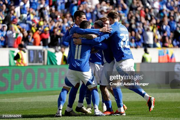 Giacomo Raspadori of Italy is congratulated by teammates after scoring a goal against Ecuador during the first half at Red Bull Arena on March 24,...