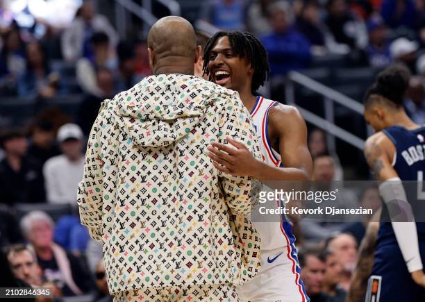 Tyrese Maxey of the Philadelphia 76ers hugs P.J. Tucker of the Los Angeles Clippers during a timeout after scoring a three pint basket during the...