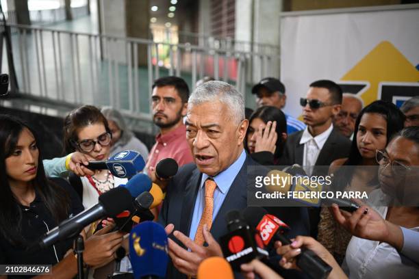 Claudio Fermin of the "Soluciones para Venezuela" political party speaks to members of the media after submitting his candidacy for the July 28...
