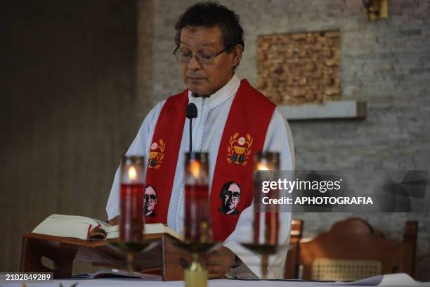 Salvadoran priest leads a mass with images of Archbishop Oscar Arnulfo Romero during the commemoration activities of the 44th Anniversary of the...