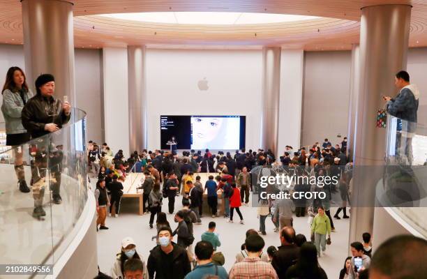 Customers shop at the ASIA'S Largest Apple Flagship Store in Shangha, China, March 23, 2024.