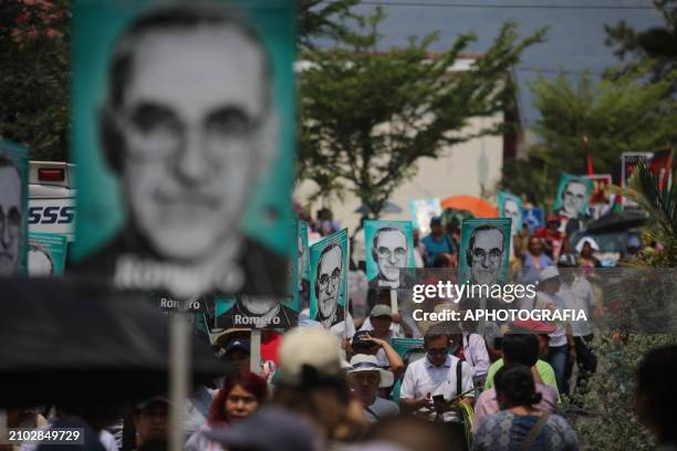People participate in a pilgrimage carrying posters with Romero's face during the commemoration activities of the 44th anniversary of the...