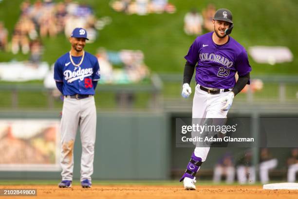 Mookie Betts of the Colorado Rockies rounds the bases after hitting a home run as Mookie Betts of the Los Angeles Dodgers looks on during the 2024...