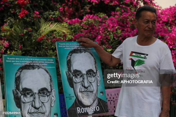 Man carrying posters with Romero's face during the commemoration activities of the 44th anniversary of the assassination of archbishop Oscar Arnulfo...