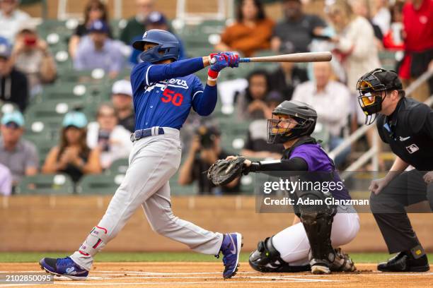 Mookie Betts of the Los Angeles Dodgers bats during the 2024 Spring Training Game between Los Angeles Dodgers and Colorado Rockies at Salt River...