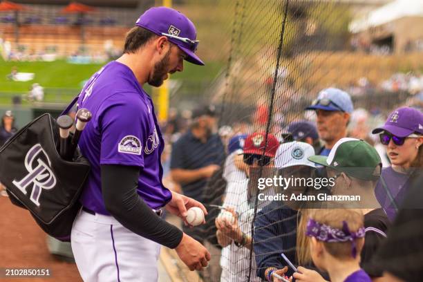 Kris Bryant of the Colorado Rockies signs autographs during the 2024 Spring Training Game between Los Angeles Dodgers and Colorado Rockies at Salt...