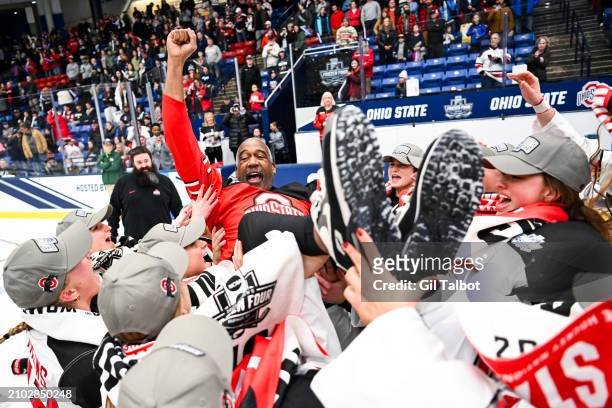 The Ohio State Buckeyes hoist athletic director Gene Smith while celebrating their win during the Division I Women's Ice Hockey Championship game...