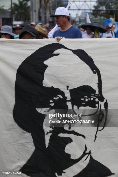 Young woman carries a Romero banner during the commemoration activities of the 44th anniversary of the assassination of archbishop Oscar Arnulfo...