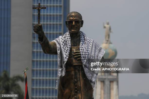 Romero monument has a kufiya on its shoulders during the commemoration activities of the 44th anniversary of the assassination of archbishop Oscar...