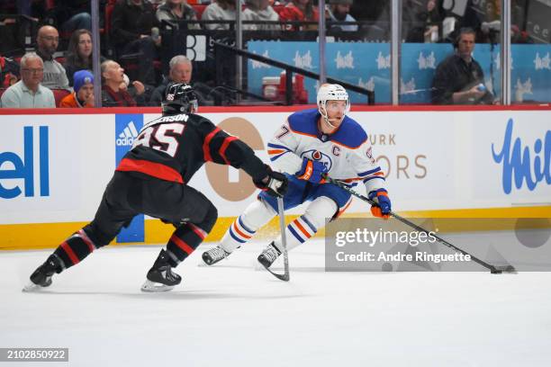 Connor McDavid of the Edmonton Oilers stickhandles the puck against Jake Sanderson of the Ottawa Senators during the second period at Canadian Tire...