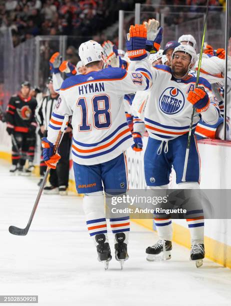 Zach Hyman of the Edmonton Oilers celebrates his second period goal against the Ottawa Senators, his 50th of the season, with teammate Leon Draisaitl...