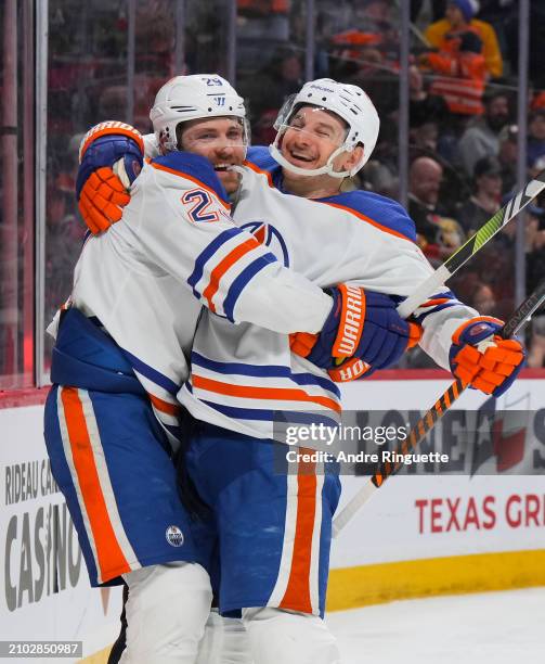 Zach Hyman of the Edmonton Oilers celebrates his second period goal against the Ottawa Senators, his 50th of the season, with teammate Leon Draisaitl...