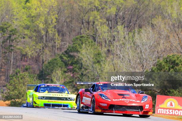 Amy Ruman, TA, McNichols Co Chevrolet Corvette leads: Boris Said, TA, Weaver Racing/STEEL-IT Dodge Challenger through Turn 3 during The...