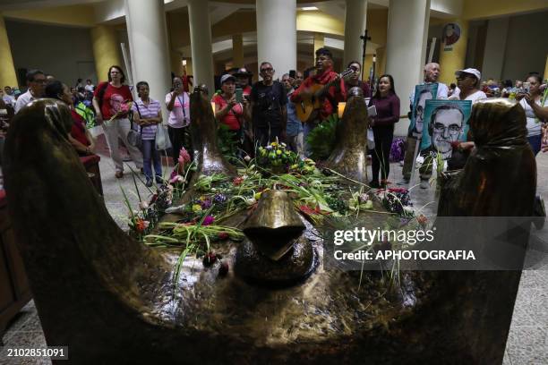 People pray in the Romero crypt in the metropolitan cathedral in the historic center during the commemoration activities of the 44th anniversary of...