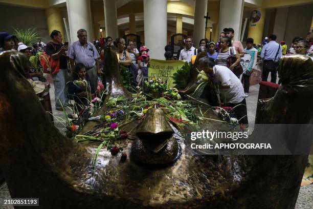 People pray in the Romero crypt in the metropolitan cathedral in the historic center during the commemoration activities of the 44th anniversary of...
