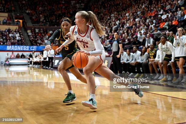 Matilda Ekh of the Virginia Tech Hokies works the baseline in the first quarter against the defense of Darianna Littlepage-Buggs of the Baylor Lady...
