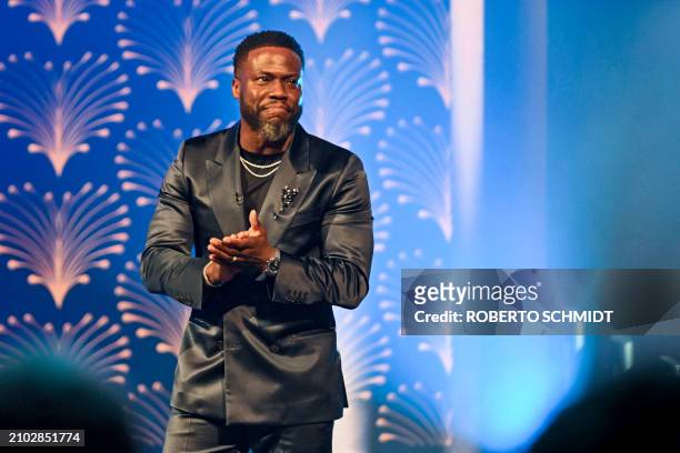 Honoree US actor comedian Kevin Hart acknowledges applause on stage during the 25th Annual Mark Twain Prize For American Humor at the John F. Kennedy...