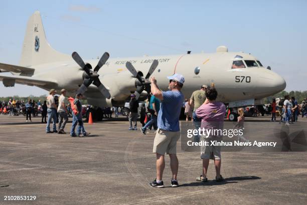 People take pictures of the aircraft during the New Orleans Airshow at Naval Air Station Joint Reserve Base in Belle Chasse, Louisiana, the United...