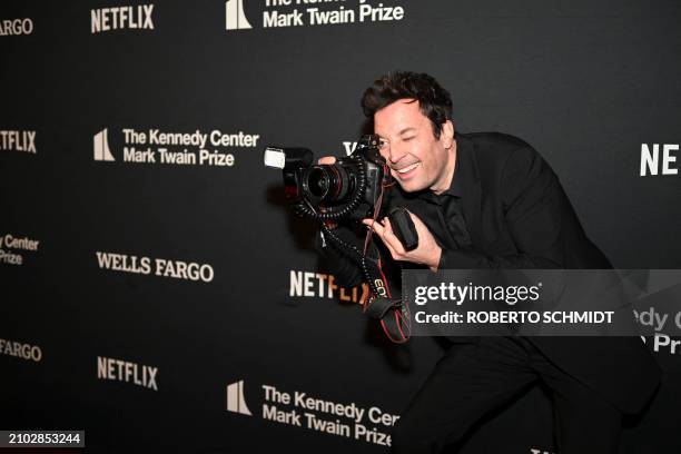 Comedian Jimmy Fallon jokes with the camera of a photographer as he arrives for the 25th Annual Mark Twain Prize For American Humor at the John F....