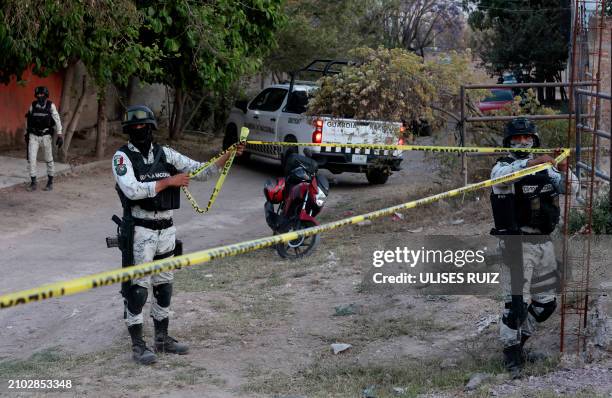 Members of the National Guard guard the area where a group of searching mothers from the collective "Guerreros Buscadores" located two clandestine...