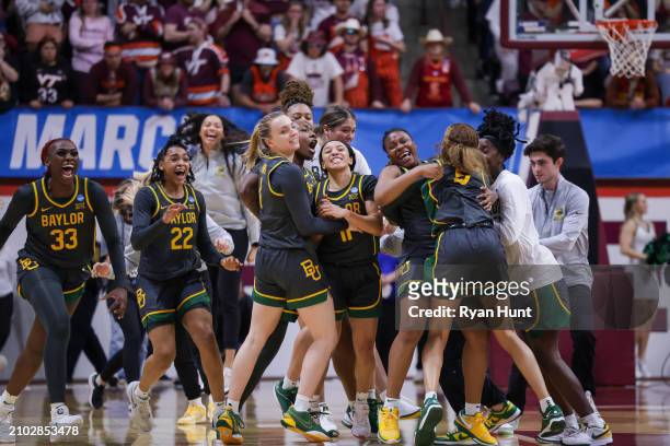 Members of the Baylor Bears celebrate after defeating the Virginia Tech Hokies at Cassell Coliseum on March 22, 2024 in Blacksburg, Virginia.