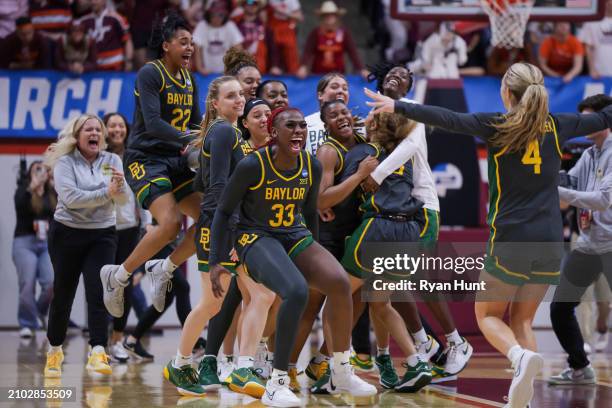 Members of the Baylor Bears celebrate after defeating the Virginia Tech Hokies at Cassell Coliseum on March 22, 2024 in Blacksburg, Virginia.