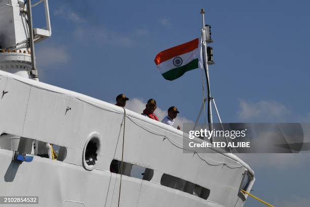 Crew and officers of Indian coast guard ship Samudra Paheredar stand on the bow as it docks during a port call at the international port in Manila on...